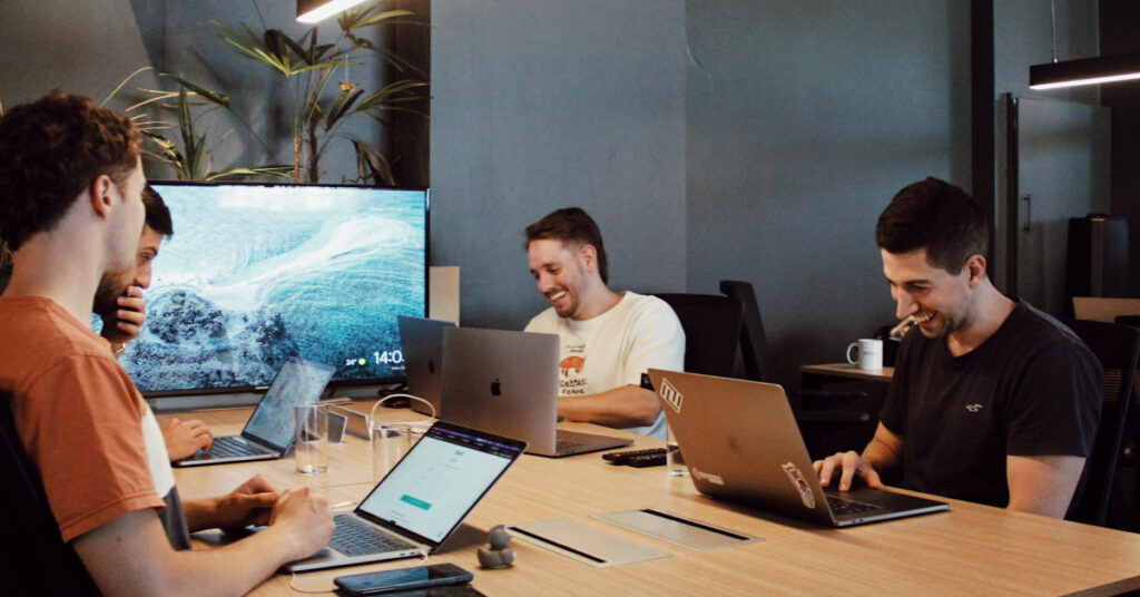 Software development team collaborating on scaling a mobile app post-MVP